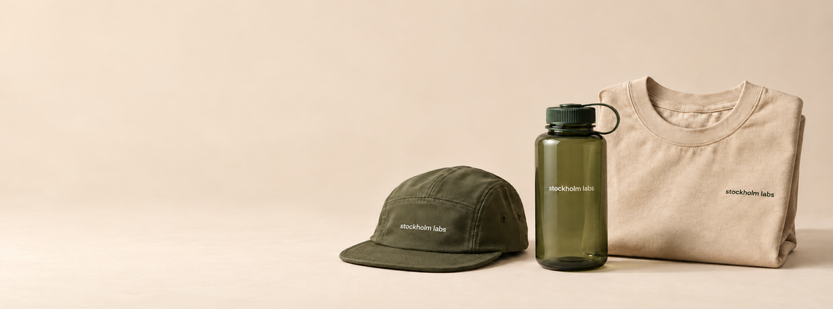 Stockholm Labs olive five-panel cap, olive water bottle and folded natural cotton T-shirt